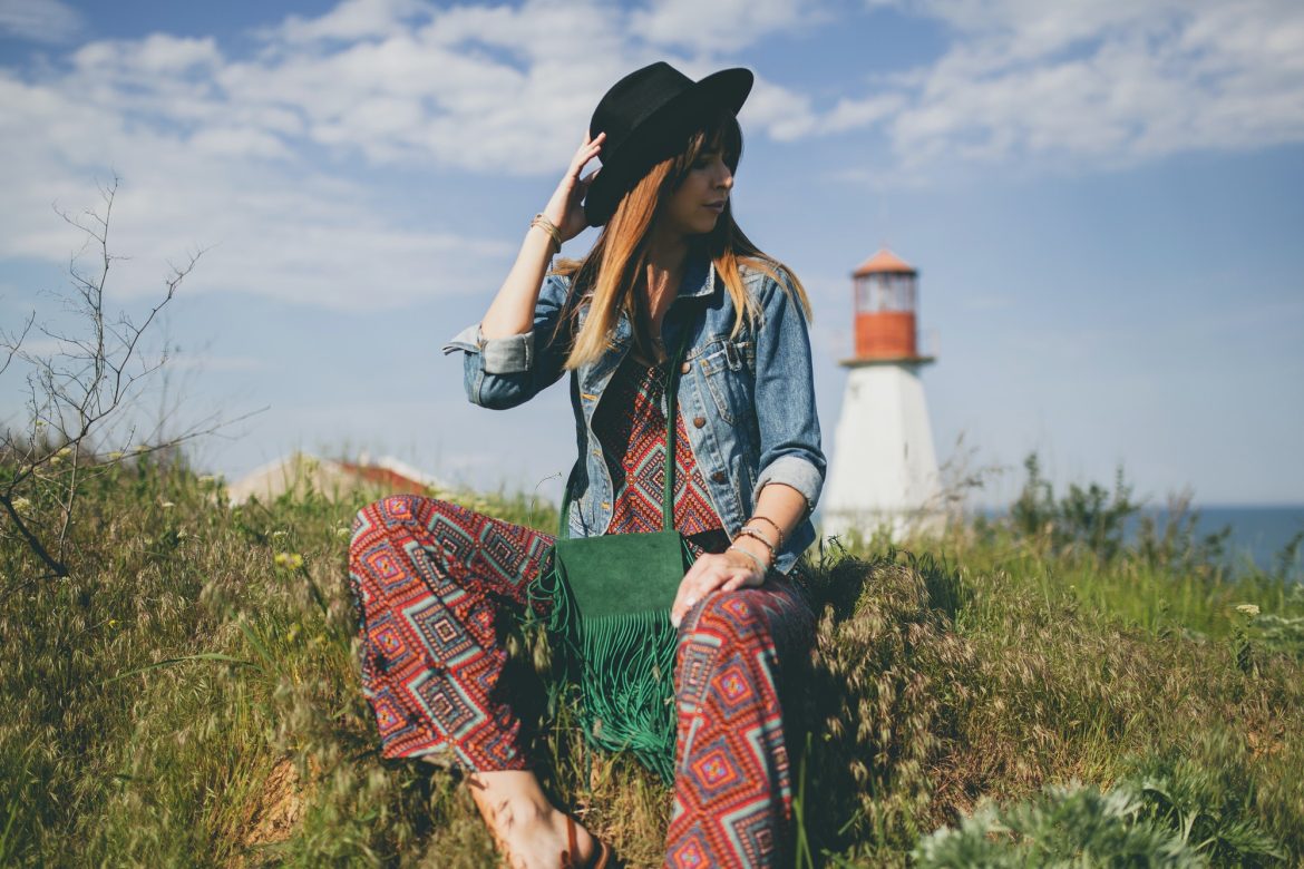 young woman in nature, lighthouse denim jacket, black hat, summer, stylish accessories